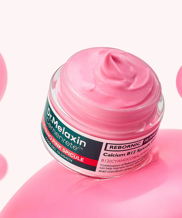 Aesthetic lifestyle shot of the Dr. Melaxin Calcium B12 Spicule Cream resting on a textured, light-colored stone surface with soft, natural shadows
