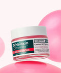 A hand holding the Dr. Melaxin Calcium B12 Spicule Cream tube, demonstrating its sleek, ergonomic design and professional medical-grade branding
