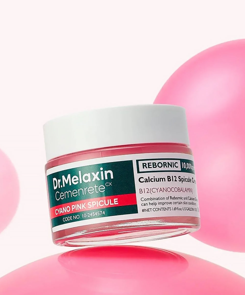 A hand holding the Dr. Melaxin Calcium B12 Spicule Cream tube, demonstrating its sleek, ergonomic design and professional medical-grade branding