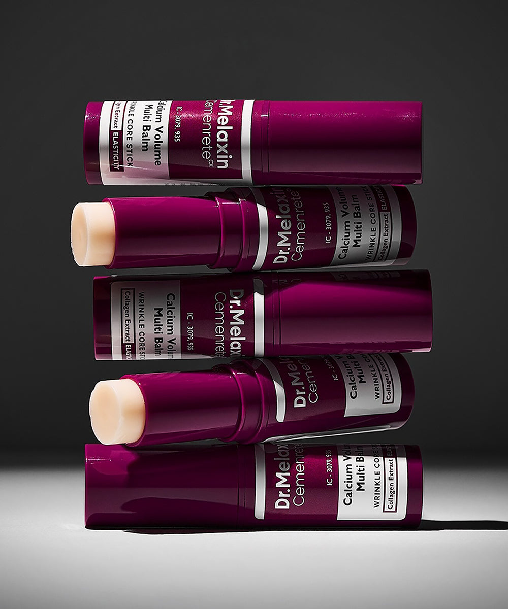 An artistic horizontal stack of five Dr. Melaxin Cemenrete Calcium Volume Multi Balm tubes, showcasing both the sleek plum packaging and the solid balm core