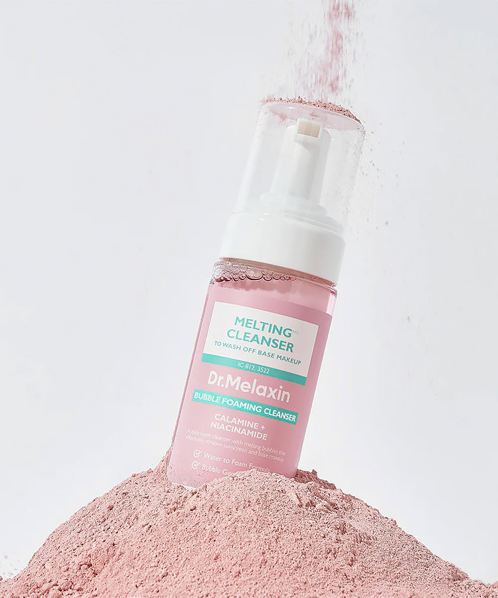 Dr. Melaxin Melting Cleanser bottle on a pile of pink powder against a light gray background