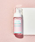 Bottle of 'Dr. Melaxin' cleansing foam on a pink background