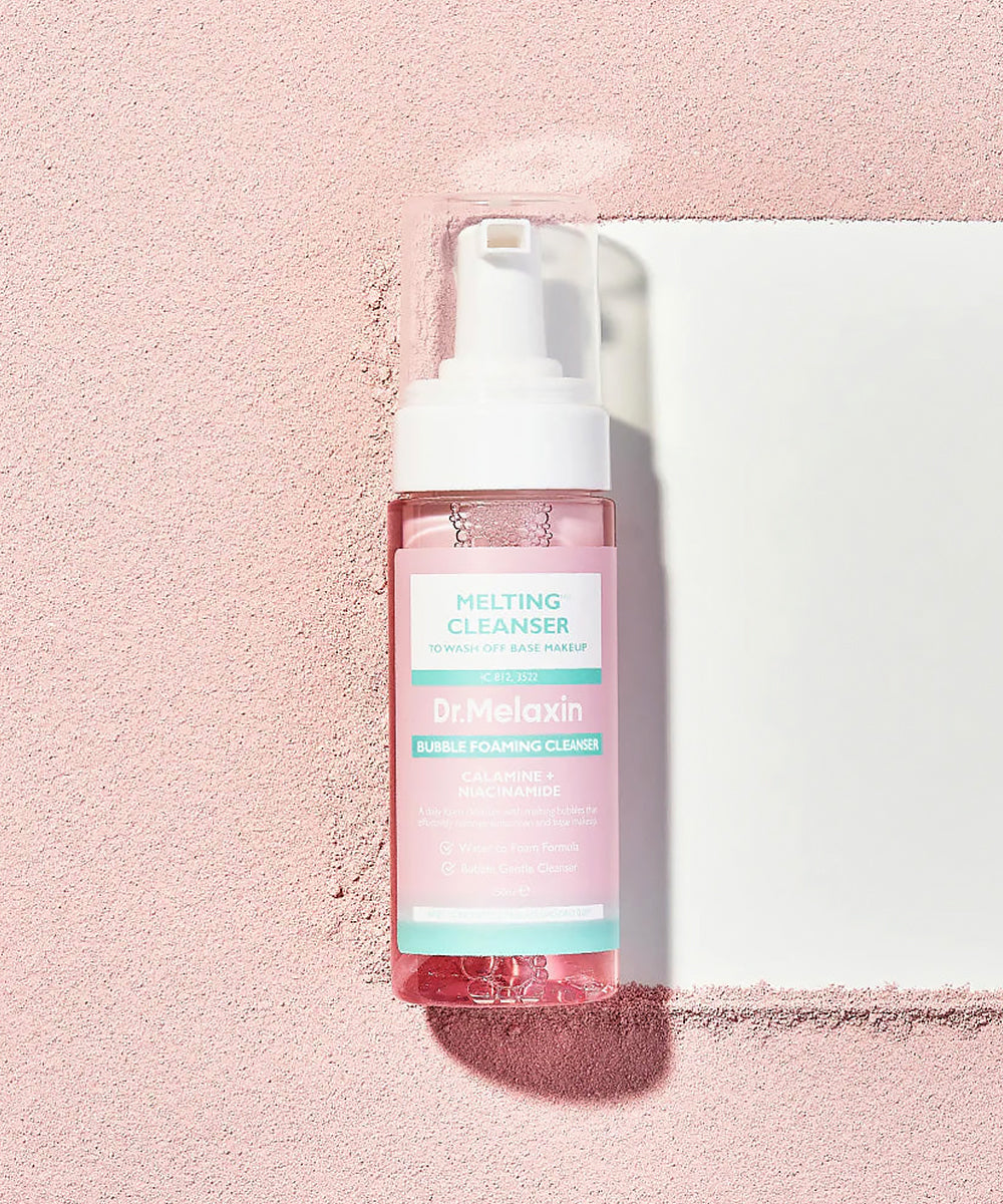 Bottle of 'Dr. Melaxin' cleansing foam on a pink background