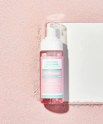 Bottle of 'Dr. Melaxin' cleansing foam on a pink background