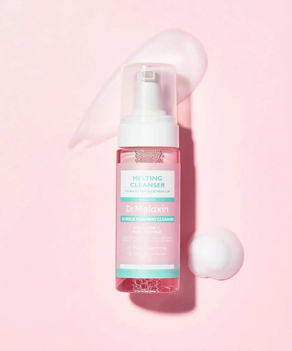 Dr. Melaxin Melting Cleanser bottle on a pink background