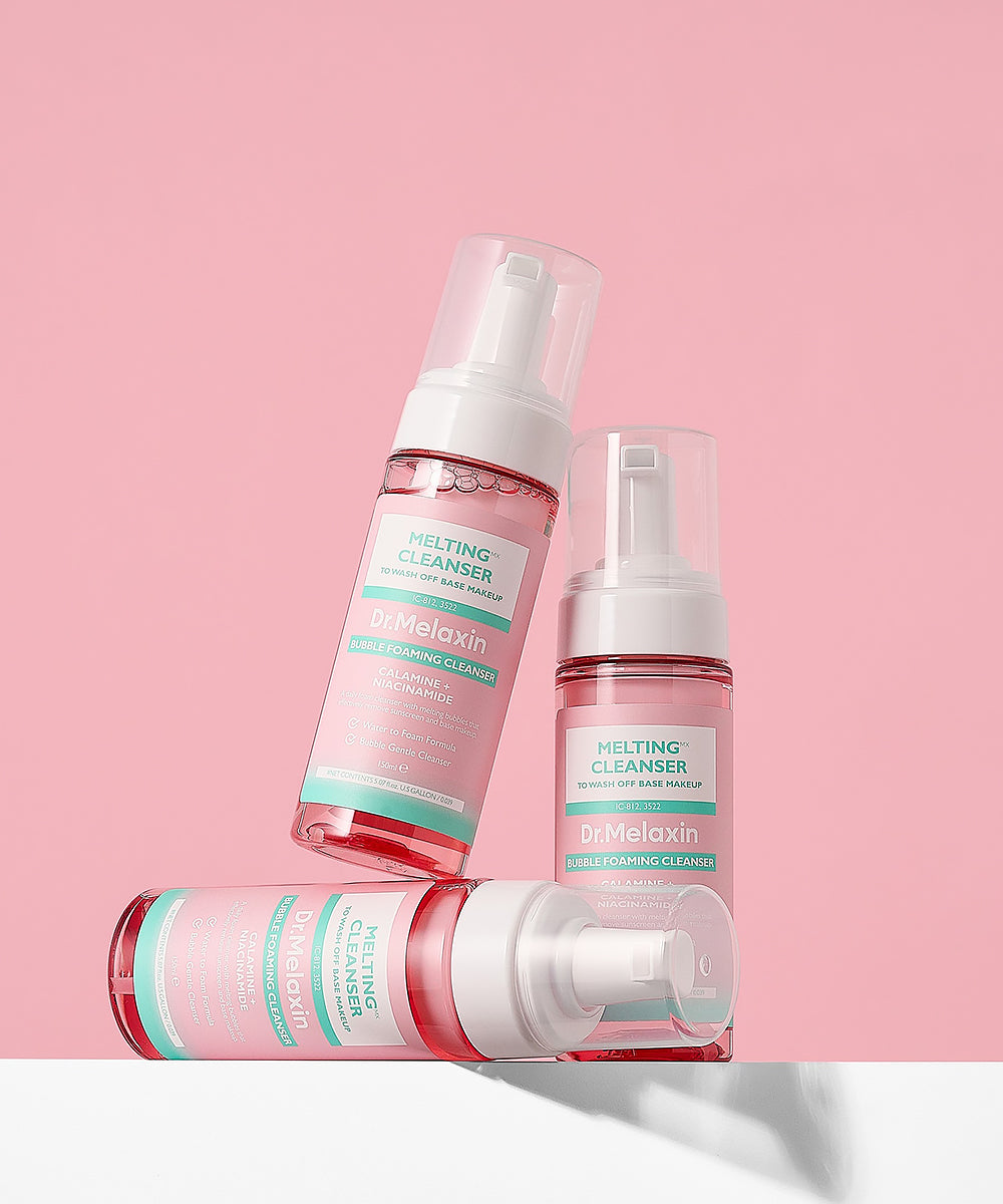 Three bottles of Dr. Melaxin cleansing products on a pink background