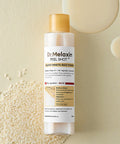 Dr. Melaxin Peel Shot Glow White Rice Toner bottle with rice grains on a beige background