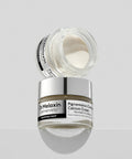 A creative stack of two Dr. Melaxin Pigmentation Corrector jars, with the top jar open to showcase the smooth, thick white cream texture inside