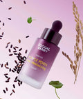 An action shot of the EQQUALBERRY Purple PDRN Pore Minimizing Serum angled among floating purple rice grains and green botanical leaves against a soft lavender background