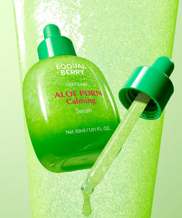 Green aloe vera serum bottle with dropper on a green background