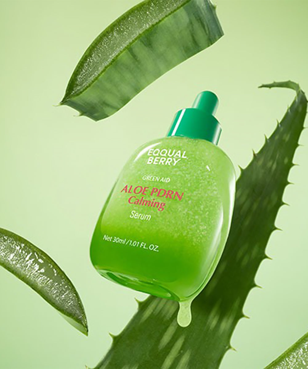 Green aloe vera serum bottle with leaves on a green background