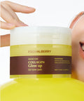 Yellow container of Equalberry Collagen Glow up Gel toner pads held by a hand.