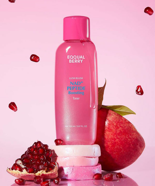 Pink bottle of Equal Berry toner with pomegranate fruits on a pink background