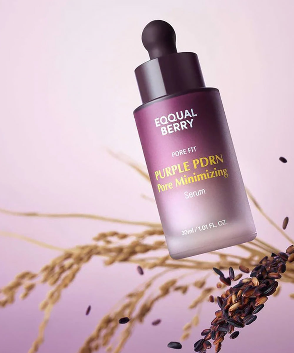 Tilted bottle of EQQUALBERRY Purple PDRN Serum displayed with stalks of grain and black rice to highlight its antioxidant-rich, grain-derived ingredients
