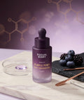 Professional lifestyle shot of EQQUALBERRY Serum on a marble tray with fresh blueberries, blackberries, and a petri dish, emphasizing its clinical yet natural formula