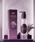 Lifestyle presentation of the ANUA Dark Spot Correcting Serum on a light stone bathroom surface, elegantly styled with a white towel and a fresh white lily