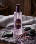 High-detail texture shot showing a glass dropper dispensing a single, glossy drop of the ANUA pink serum to demonstrate its viscous and hydrating consistency