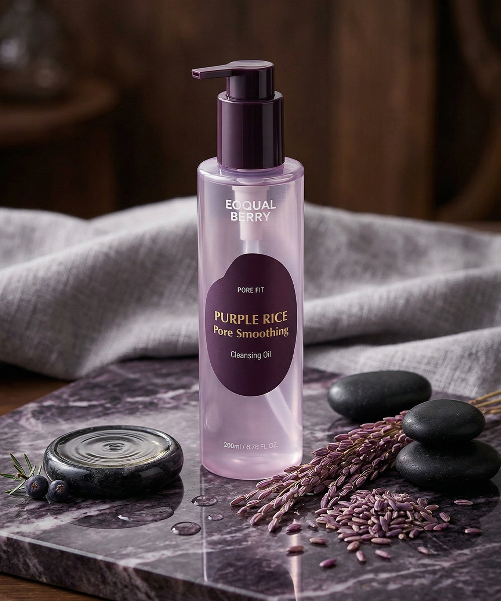 High-detail texture shot showing a glass dropper dispensing a single, glossy drop of the ANUA pink serum to demonstrate its viscous and hydrating consistency