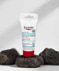 Eucerin Advanced Repair Hand Cream on a white background with volcanic rocks.