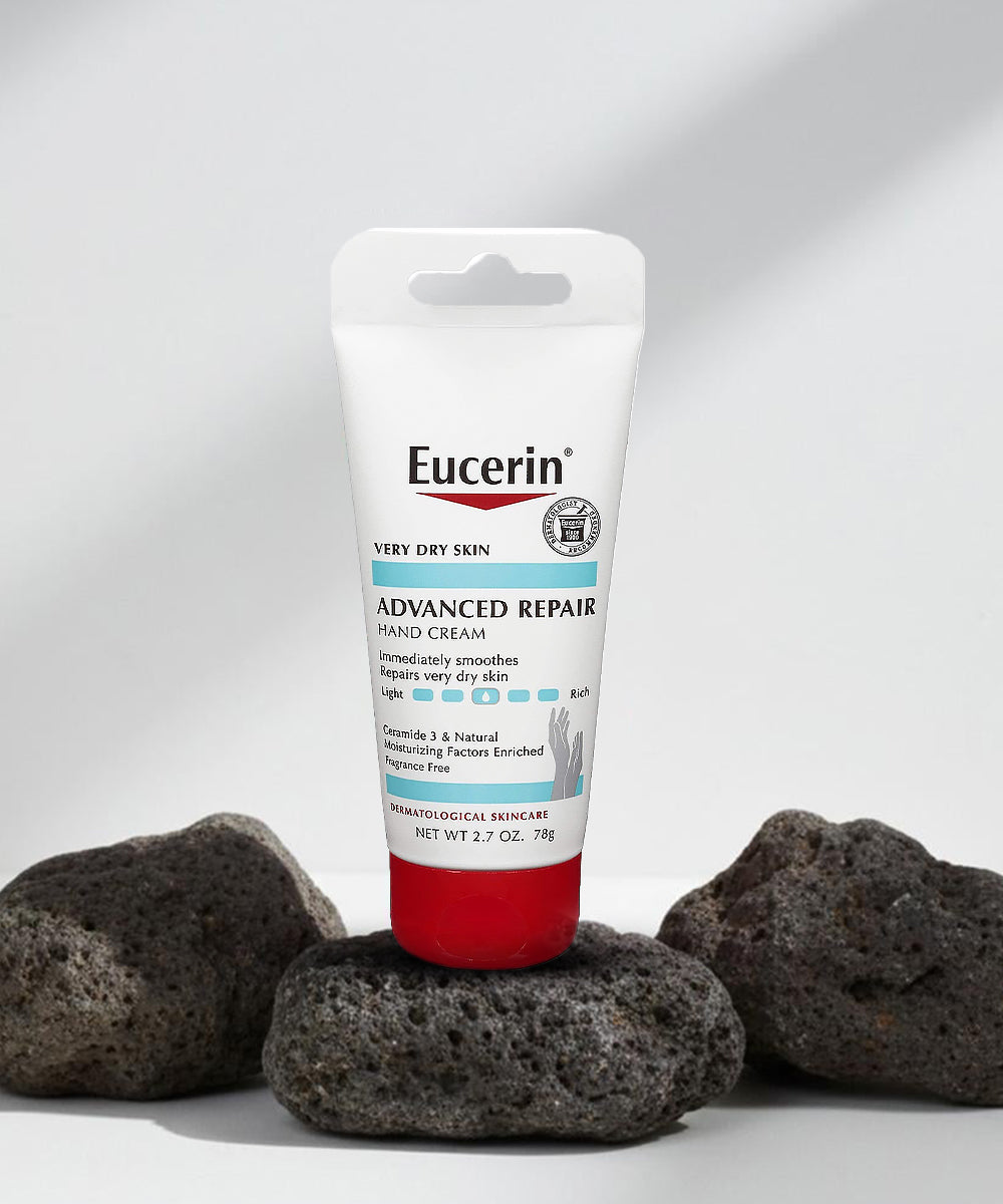 Eucerin Advanced Repair Hand Cream on a white background with volcanic rocks.