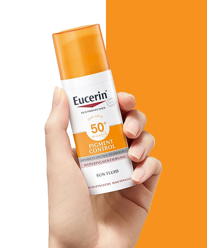 Eucerin sun protection product held in a hand with an orange background