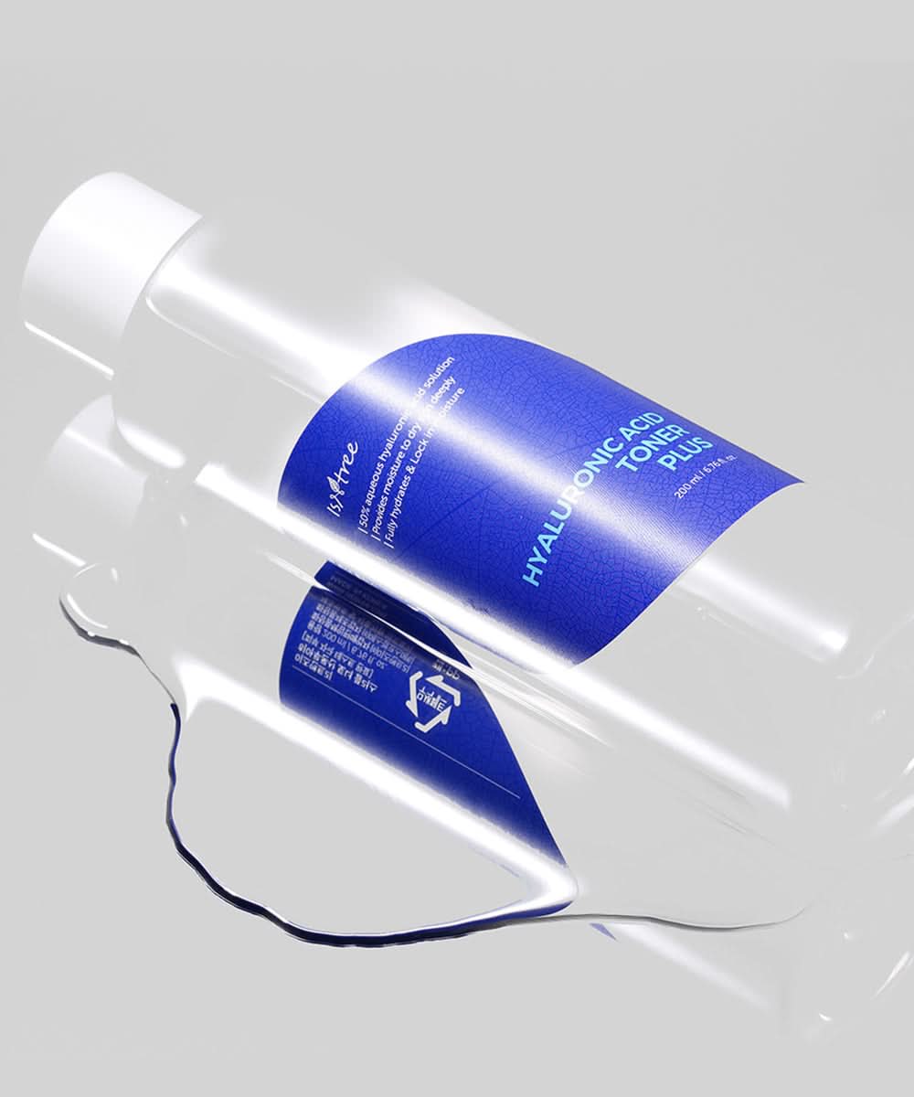 Two bottles of 'Hyaluronic Acid Toner Plus' with blue labels on a reflective surface.