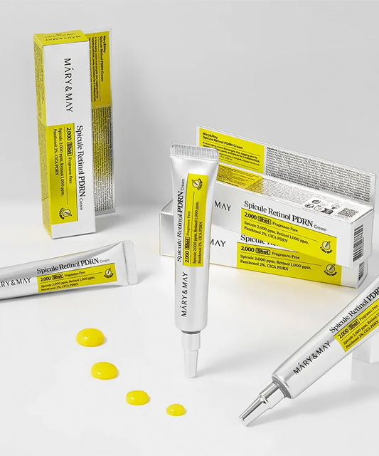 Close-up of the Bioderma Sébium Kerato+ tube with the cap removed, showing the precision applicator nozzle and a small sample of the white gel-cream on a fingertip