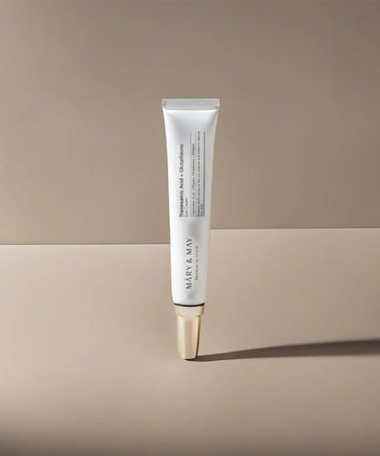Skincare tube with gold cap on a beige background