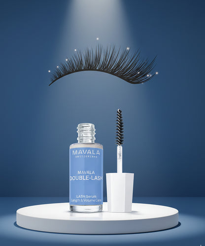 Mavala Double-Lash lash serum with applicator and false lashes on a blue background