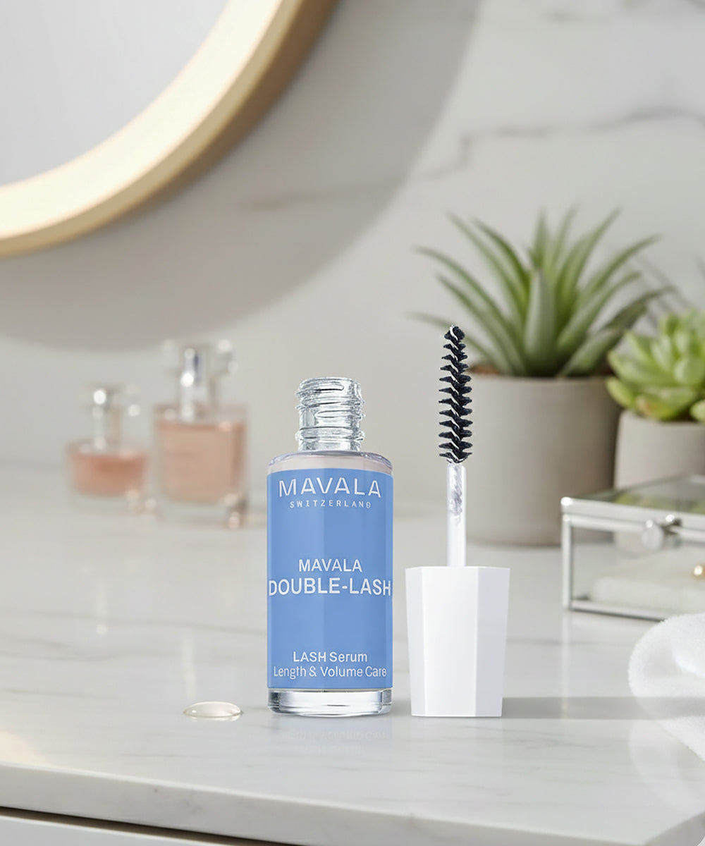 Mavala Double-Lash lash serum with applicator on a bathroom counter.