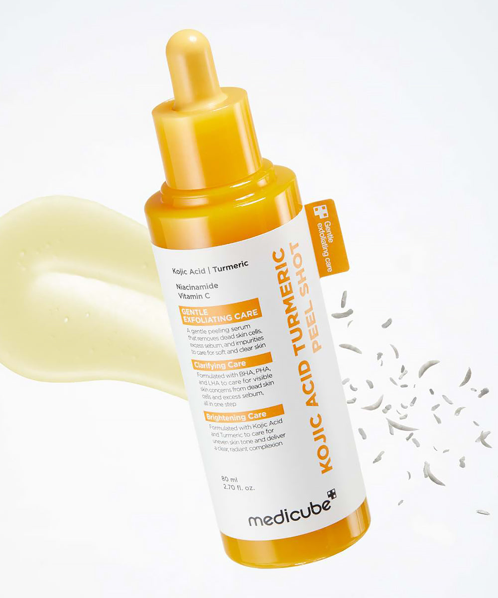 Lifestyle shot of The Medicube Kojic Acid Turmeric Peel Shot next to its retail box, positioned under bright, clean lighting to reflect professional dermatological quality