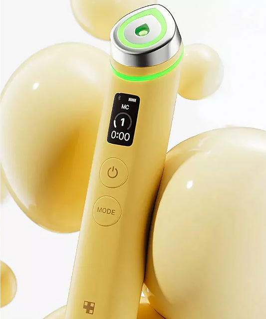 Close-up of the Medicube Age-R Booster Pro treatment head glowing with vibrant pink LED light, illustrating the device's skin-boosting technology for enhanced product absorption