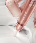 Rose gold skincare serum bottles with 'medicube' branding on a light background