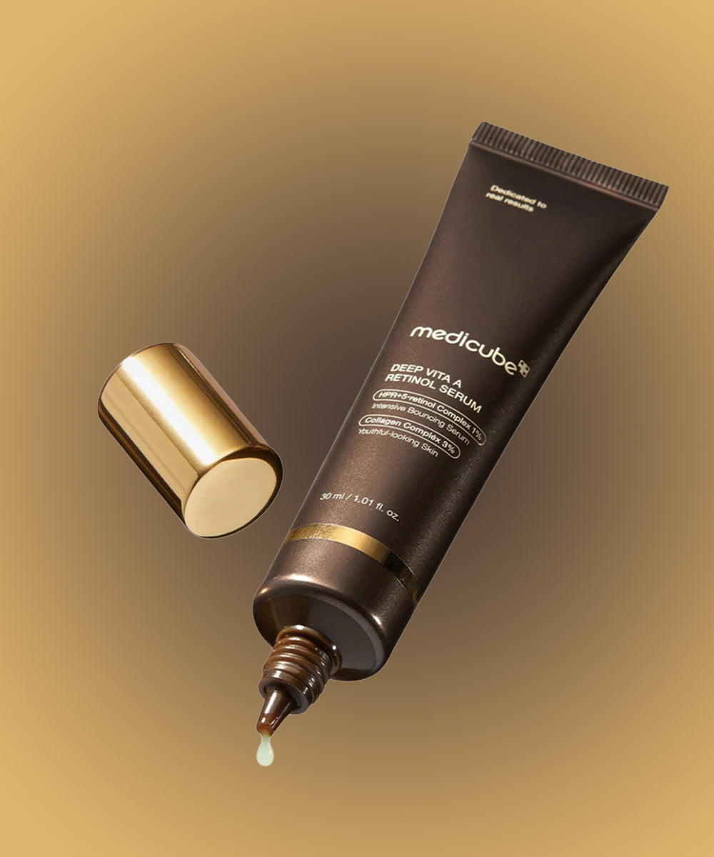 Medicube serum tube with dropper on a gradient gold background