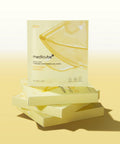 Stack of medicube gel mask boxes on a yellow background