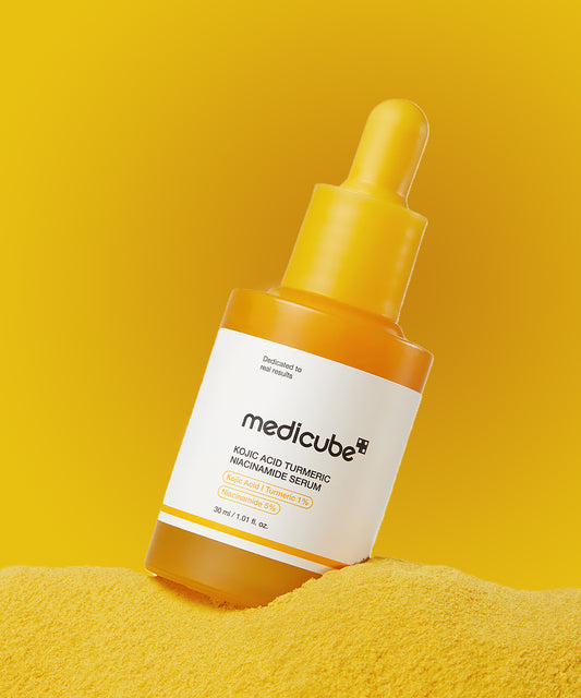 Medicube serum bottle with dropper on a yellow background