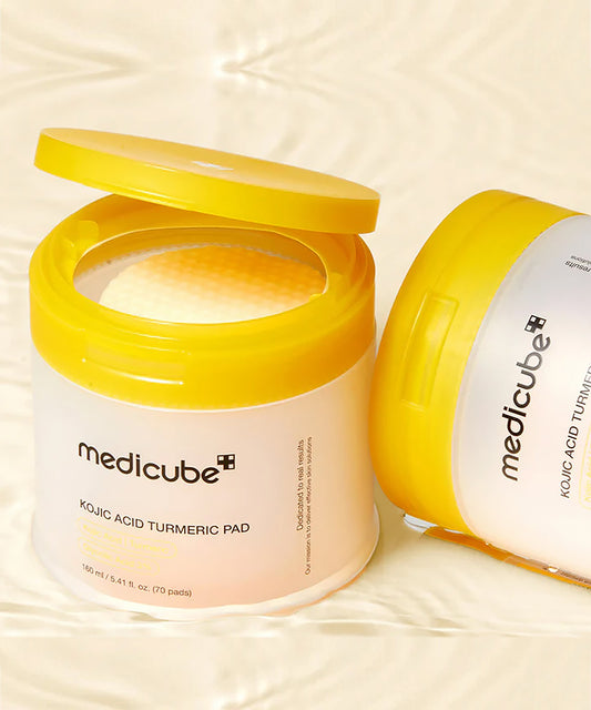 Medicube Kojic Acid Turmeric Pad packaging on a beige background