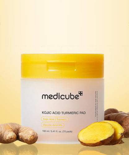 Medicube Kojic Acid Turmeric Pad packaging with turmeric roots on a yellow background