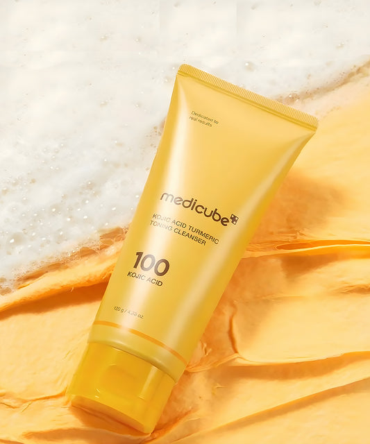 Yellow tube of Medicube cleanser on a textured yellow fabric background