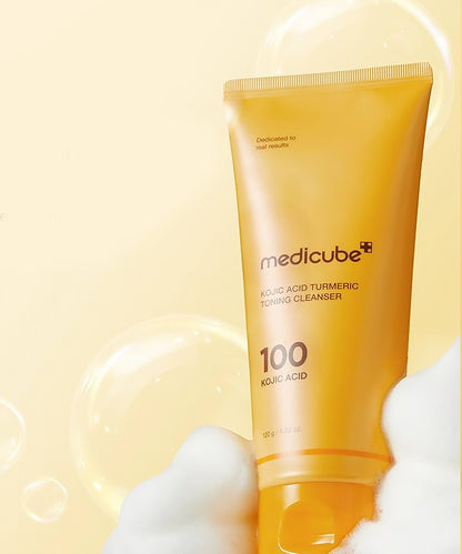 Medicube Kojic Acid Turmeric Toning Cleanser on a beige background