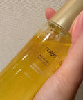 Hand holding a bottle of Medicube Kojic Acid Vita Jelly against a neutral background