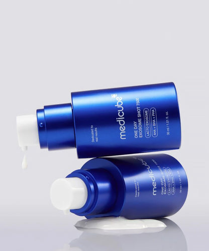 Two blue skincare bottles with white caps on a light gray background