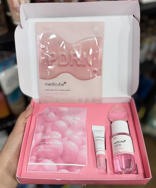 Medicube skincare product set in a pink box held by a hand.