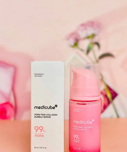 Medicube pink collagen bubble serum bottle and box on a pink background
