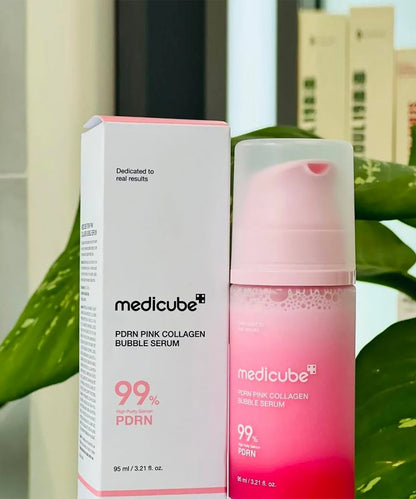 Medicube PDRN Pink Collagen Bubble Serum with packaging against a blurred outdoor background