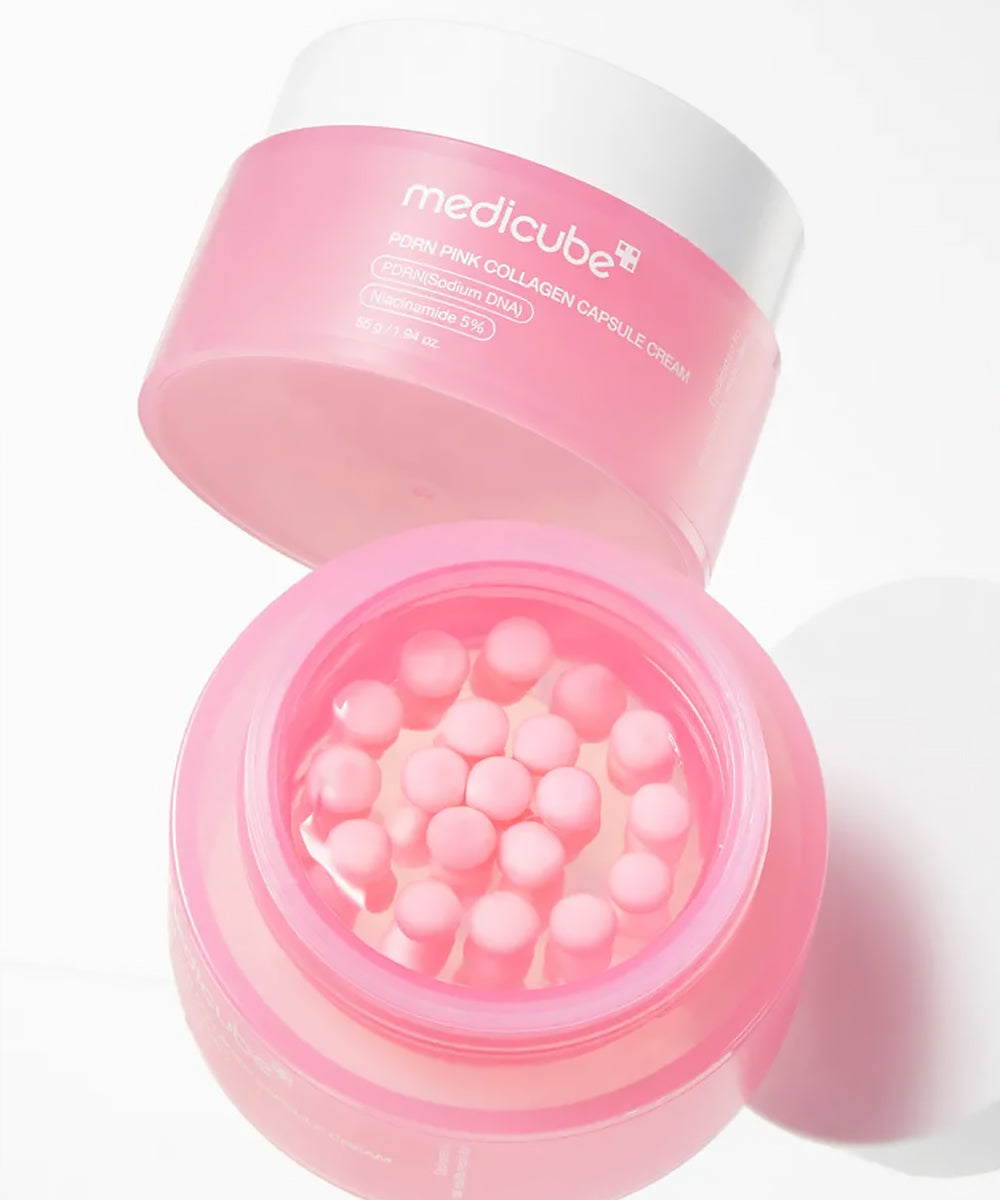 Pink jar of Medicube cream with open lid on a white background