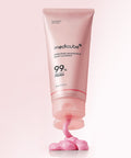 Vertical product shot of the Medicube PDRN Pink Niacinamide Whip Cleanser standing on a pink background, with a dollop of the rich pink cleanser being actively dispensed from the nozzle to showcase its glossy texture