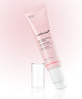 Pink eye cream tube with applicator on a light pink background