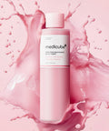 Medicube pink bottle with pink liquid splashes on a pink background
