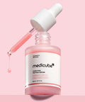 Medicube Pink Peptide Serum bottle with dropper on a pink background